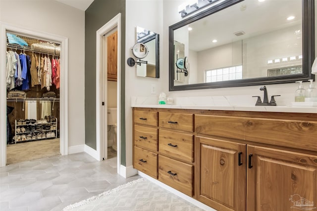 bathroom featuring vanity and toilet