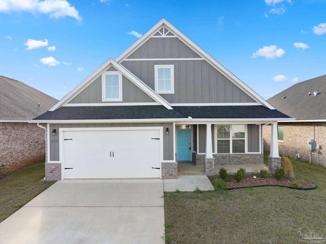 craftsman-style house featuring board and batten siding, concrete driveway, a front lawn, and a garage