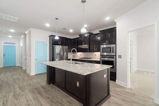2339 Habersham Ln, Cantonment, FL 32533 - kitchen with an island with sink, stainless steel appliances, light countertops, pendant lighting, and backsplash