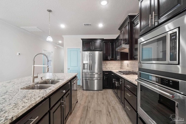 2339 Habersham Ln, Cantonment, FL 32533 - kitchen featuring stainless steel appliances, visible vents, hanging light fixtures, light wood-style floors, and a sink