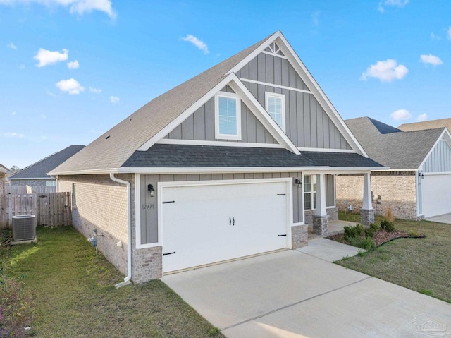 craftsman house with brick siding, fence, driveway, a front lawn, and board and batten siding