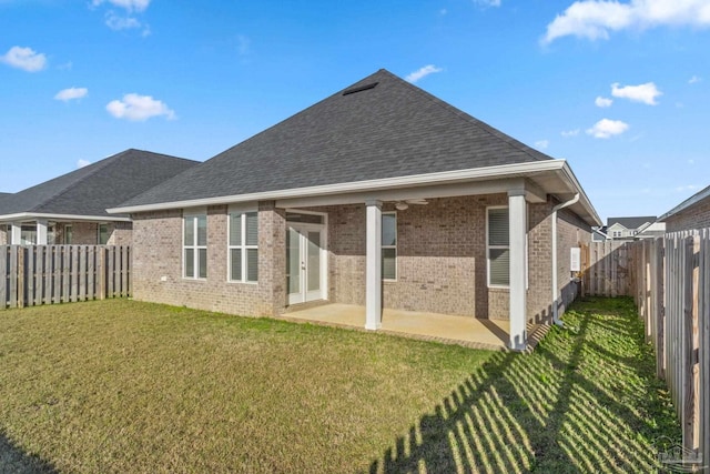 2339 Habersham Ln, Cantonment, FL 32533 - back of house featuring a shingled roof, brick siding, and a patio