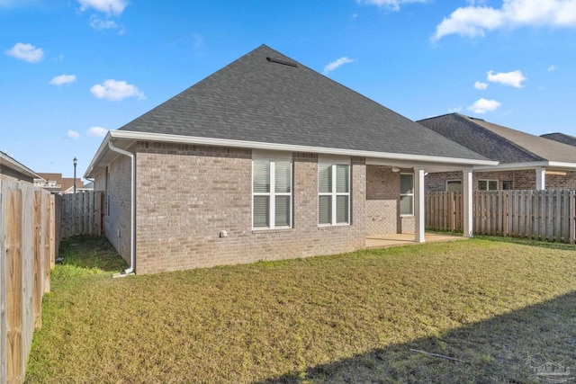 2339 Habersham Ln, Cantonment, FL 32533 - back of house featuring a yard, brick siding, and a fenced backyard