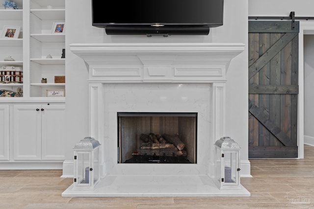 4726 Soundside Dr, Gulf Breeze, FL 32563 - detailed view of wood finished floors, a fireplace, a barn door, and built in shelves