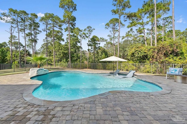 view of swimming pool featuring pool water feature and a patio area