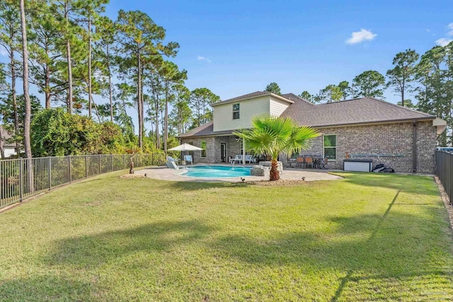 view of yard featuring a patio and a fenced in pool