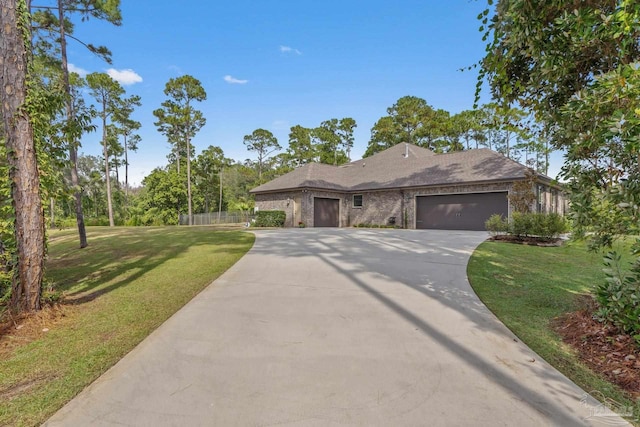 view of front of property featuring a front yard and a garage