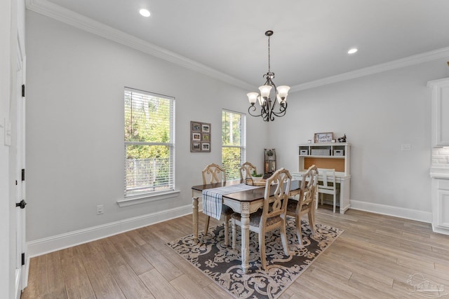 dining area with ornamental molding, a notable chandelier, and light wood-type flooring