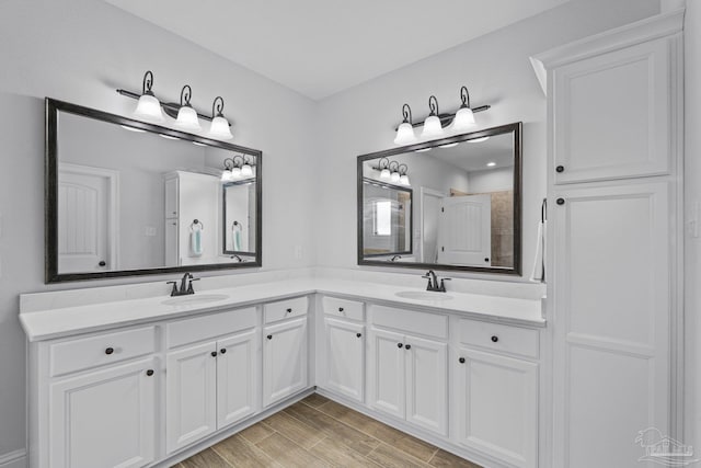 bathroom with vanity, hardwood / wood-style flooring, and a shower