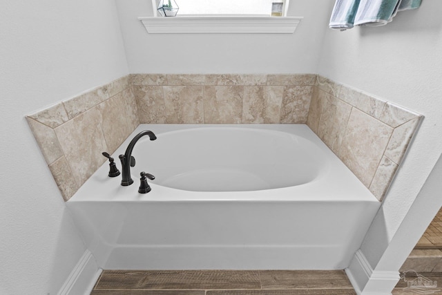 bathroom featuring hardwood / wood-style floors and a bathtub