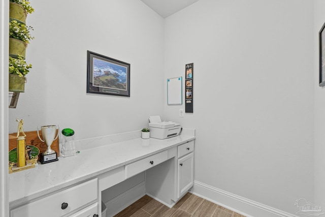 4726 Soundside Dr, Gulf Breeze, FL 32563 - office area with light wood finished floors, built in study area, and baseboards