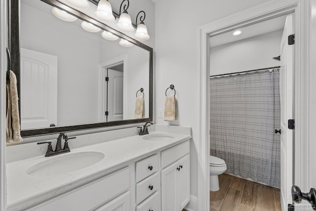 bathroom with vanity, curtained shower, wood-type flooring, and toilet