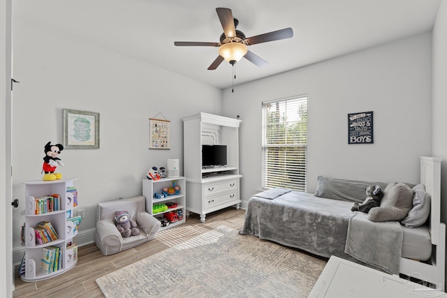 bedroom with light wood-type flooring and ceiling fan