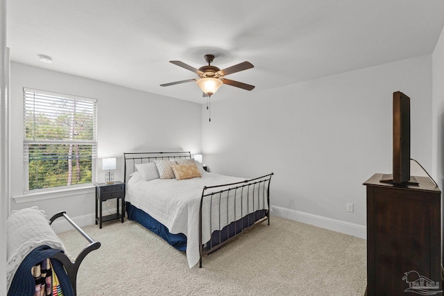 bedroom featuring light carpet and ceiling fan