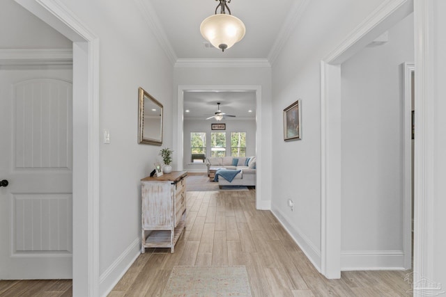 hallway featuring ornamental molding and light wood-type flooring