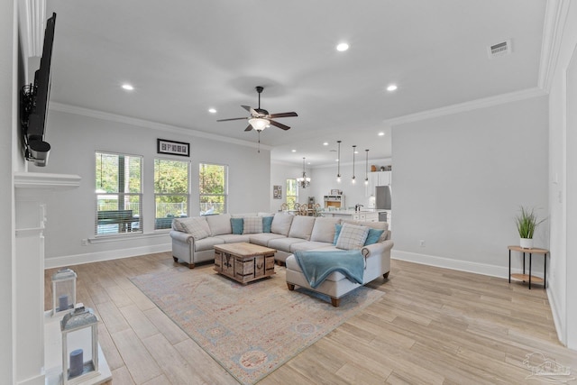 living room with crown molding, light hardwood / wood-style flooring, and ceiling fan with notable chandelier