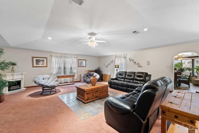 living room with light carpet, a textured ceiling, and ceiling fan