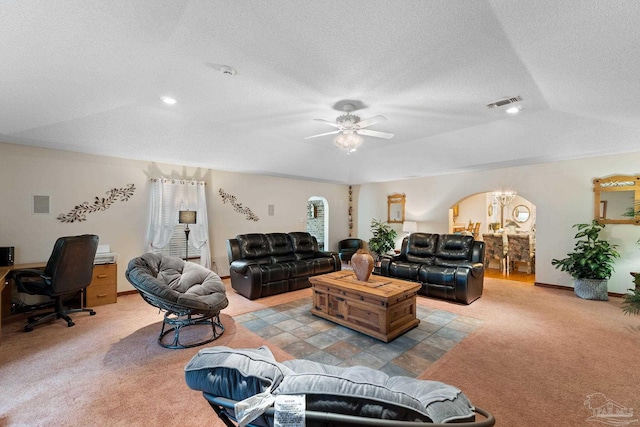 living room with lofted ceiling, ceiling fan, light colored carpet, and a textured ceiling