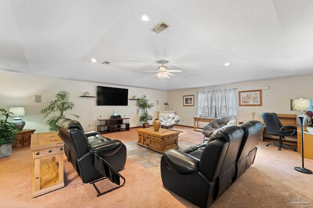 living room with a textured ceiling and ceiling fan