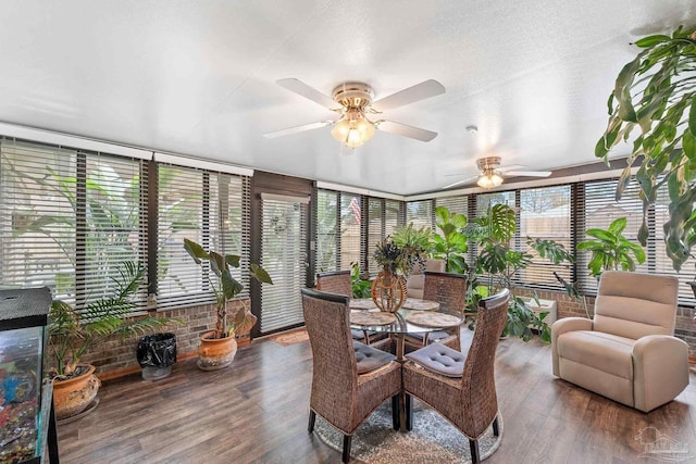 sunroom featuring ceiling fan