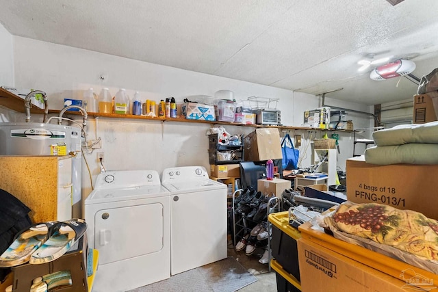 clothes washing area with a textured ceiling, separate washer and dryer, and water heater