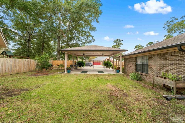 view of yard featuring a patio and ceiling fan