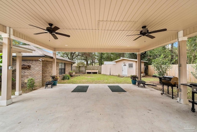 view of patio / terrace with ceiling fan, area for grilling, and an outdoor structure