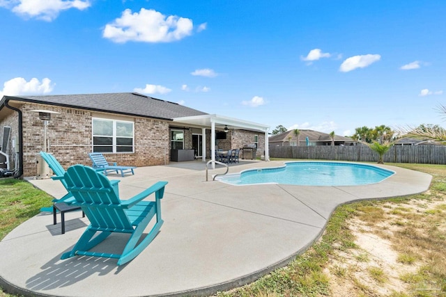 view of swimming pool with a fenced backyard, a ceiling fan, a fenced in pool, and a patio area