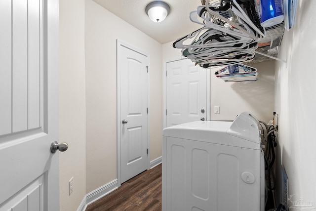laundry area with washer / dryer, baseboards, laundry area, and dark wood-type flooring