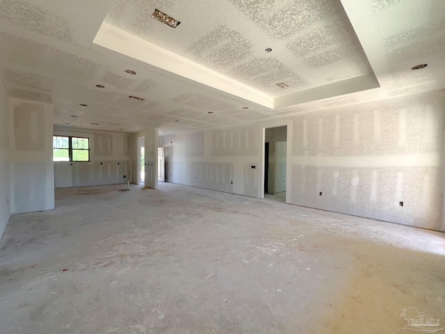 spare room with a tray ceiling