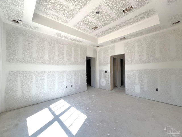 unfurnished room with a tray ceiling