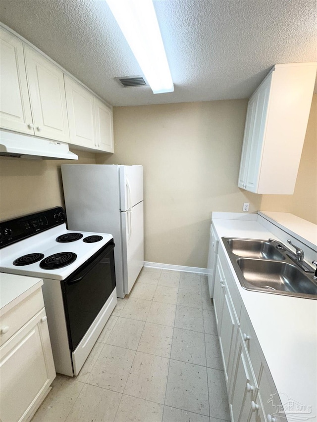 kitchen featuring white appliances, sink, a textured ceiling, and white cabinets