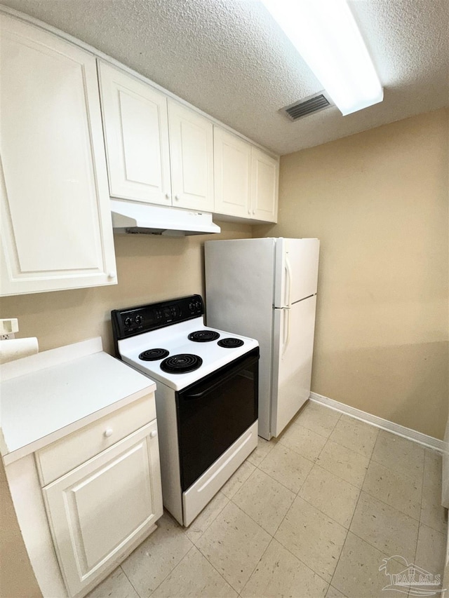 kitchen featuring range with electric stovetop, white refrigerator, white cabinets, and a textured ceiling