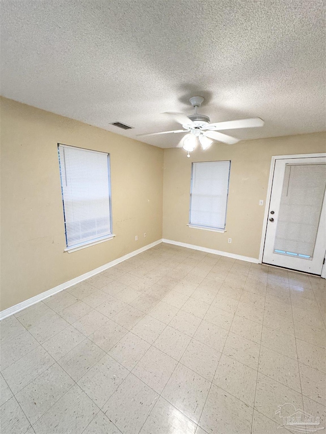 spare room featuring a textured ceiling and ceiling fan