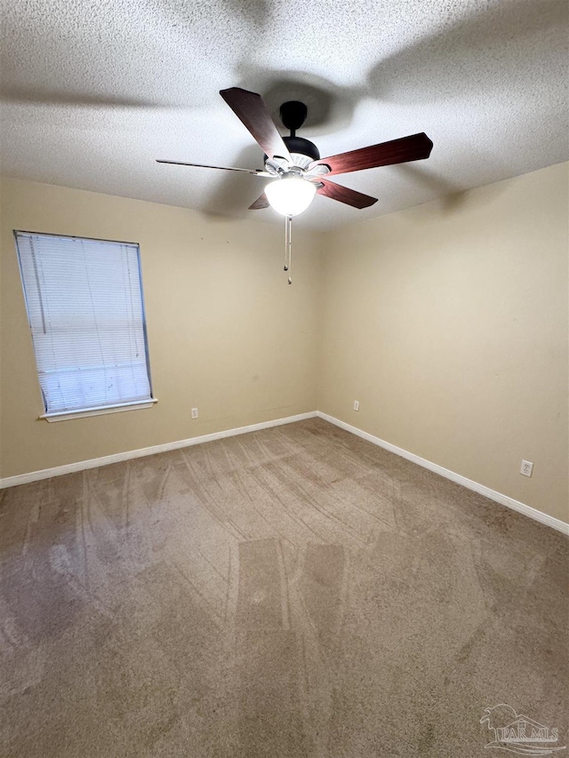 unfurnished room featuring ceiling fan, carpet, and a textured ceiling