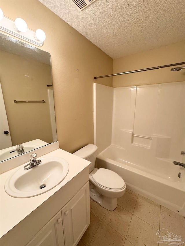 full bathroom featuring toilet, a textured ceiling, vanity, shower / bath combination, and tile patterned flooring