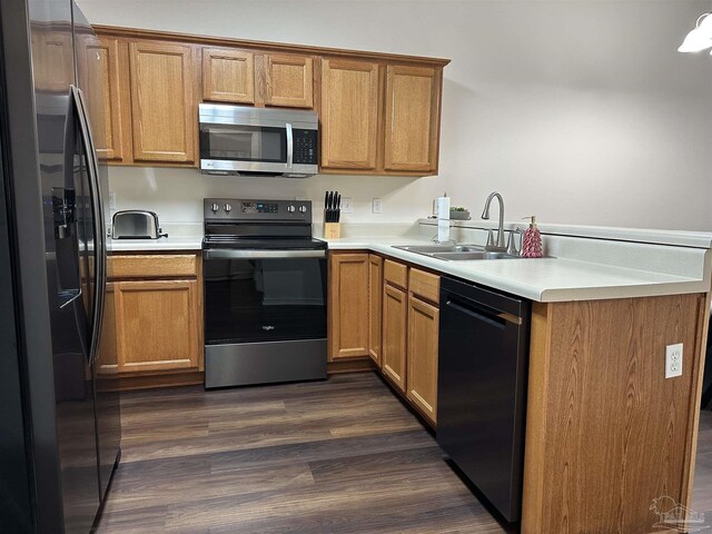 kitchen featuring pendant lighting, kitchen peninsula, appliances with stainless steel finishes, and a chandelier