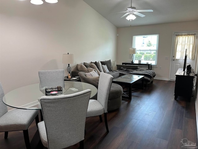 dining area featuring dark hardwood / wood-style floors, ceiling fan, and vaulted ceiling