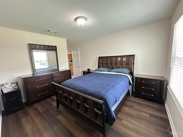 bathroom with walk in shower, hardwood / wood-style flooring, a textured ceiling, and toilet