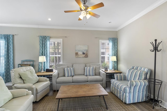 living room with crown molding, dark wood finished floors, a ceiling fan, and a healthy amount of sunlight