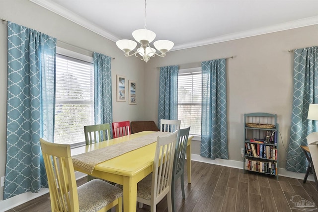 dining space with baseboards, ornamental molding, wood finished floors, and an inviting chandelier