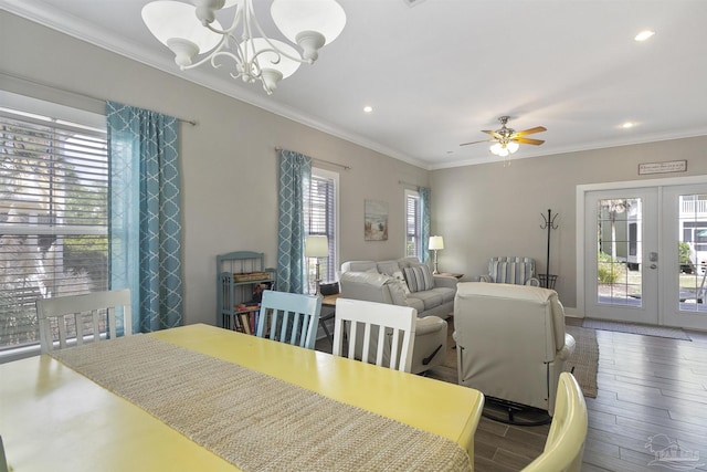 dining room featuring ornamental molding, wood finished floors, ceiling fan with notable chandelier, french doors, and recessed lighting