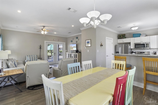 dining room with ornamental molding, wood tiled floor, french doors, and visible vents