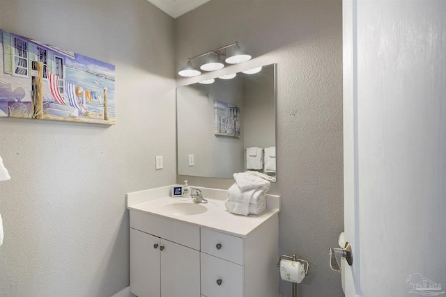 bathroom featuring a textured wall and vanity