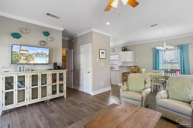 living area with ceiling fan with notable chandelier, dark wood-style flooring, visible vents, and baseboards