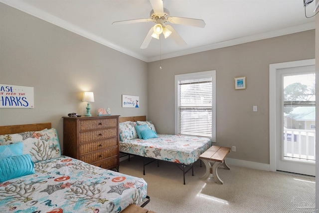 carpeted bedroom with ceiling fan, baseboards, and crown molding