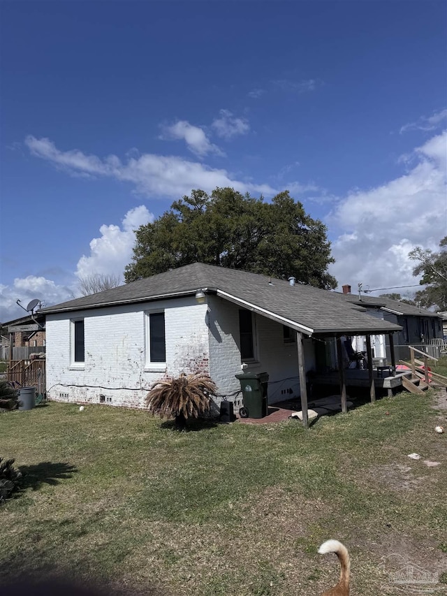 view of property exterior with crawl space, a yard, and brick siding