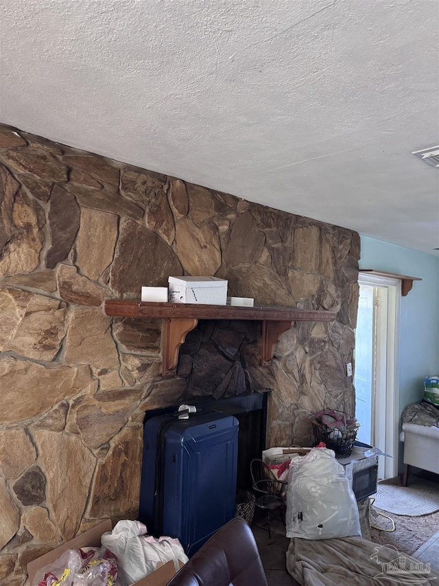 room details with a wood stove and a textured ceiling