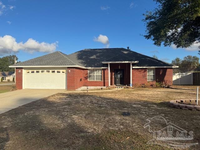 ranch-style home with brick siding, concrete driveway, and an attached garage