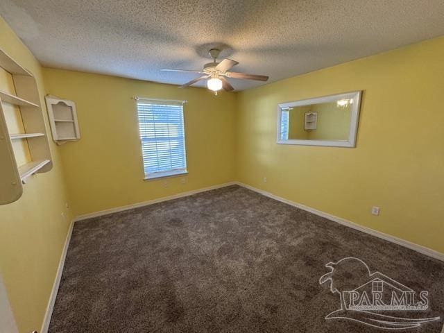 carpeted spare room with a textured ceiling and ceiling fan